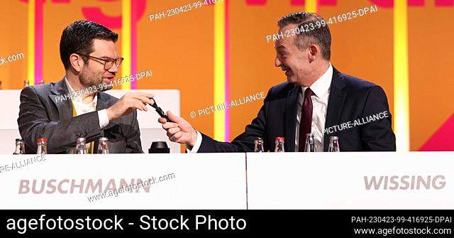 23 April 2023, Berlin: Marco Buschmann (l, FDP), Federal Minister of Justice, hands Volker Wissing (FDP), Federal Minister of Transport