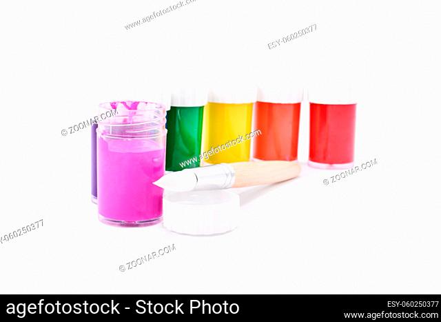 Color paint containers and a paint brush, isolated on white background