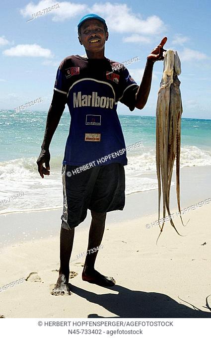 Local fisherman with two big octopus, Madagascar