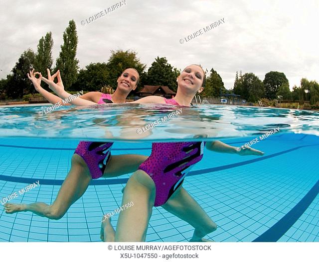 Greta Britain synchronised swimming team duet competitors, Jenna Randall 20, left and Olivia Allison 19  Shot at the heated pool of 1930's Guildford Lido