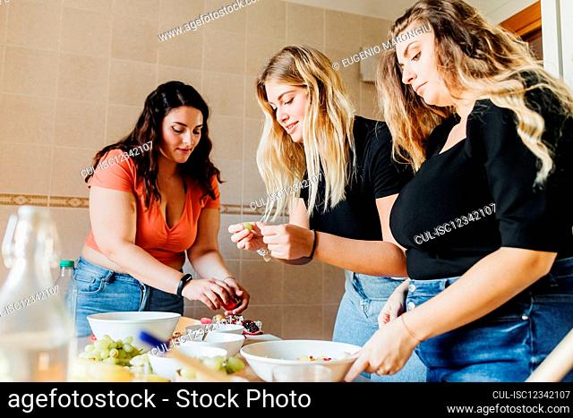 Female friends preparing meal together