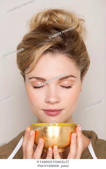 Woman holding a bowl of green tea