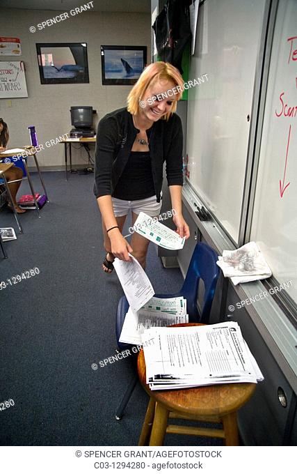 A Southern California high school student turns in a completed multiple choice examination  Note pencil-marked Scantron card to allow electronic scoring