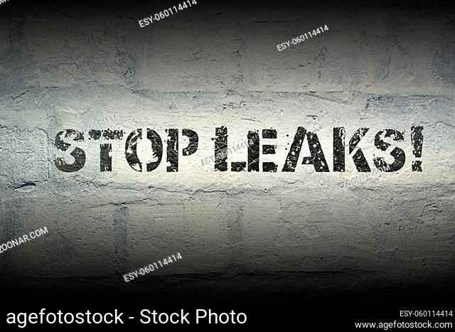 stop leaks stencil print on the grunge white brick wall