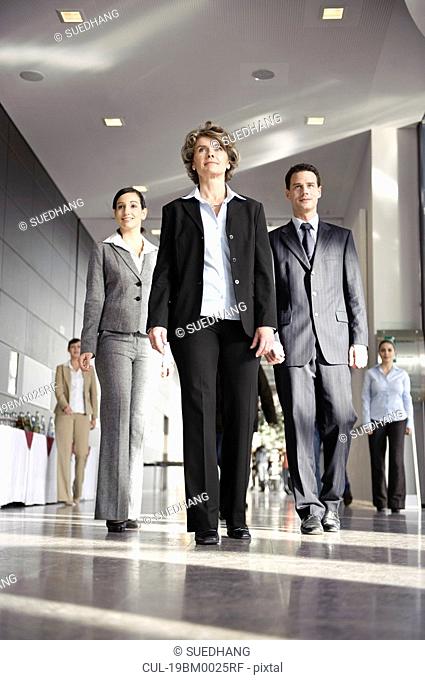 Business people walking towards camera