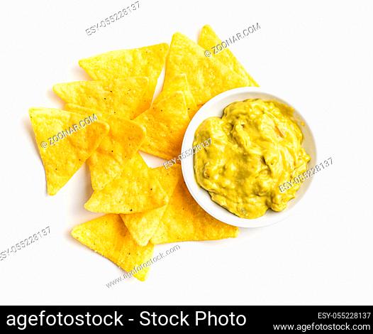 Corn nacho chips and avocado dip. Yellow tortilla chips and guacamole isolated on white background