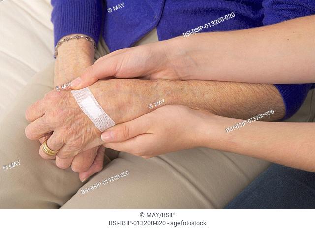 bandage on poly arthritis hand senior woman