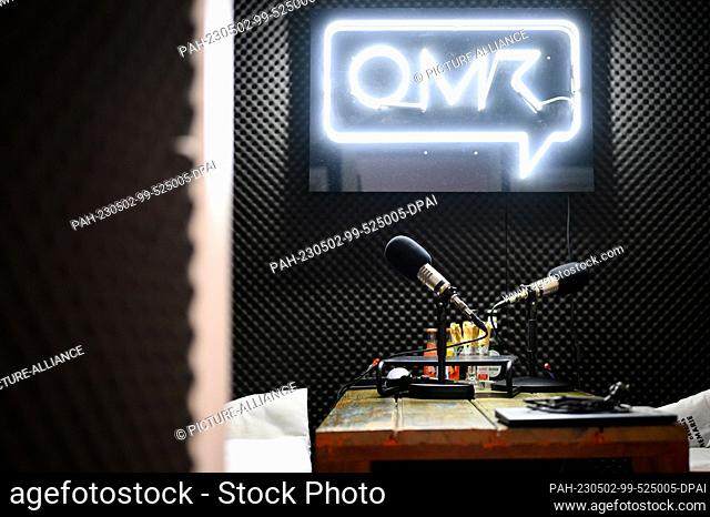 PRODUCTION - 17 April 2023, Hamburg: Podcast microphones stand in a recording studio in front of the OMR company logo. When the team from Hamburg-based media...