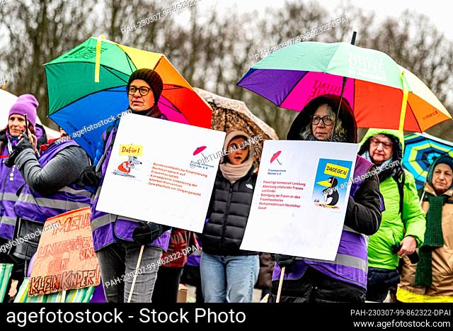 07 March 2023, Berlin: Participants stand at a protest rally for the nationwide strike of autonomous women's shelters in March 18 Square on the eve of...