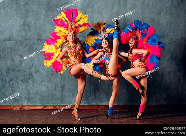 Three Woman in cabaret costume with colorful feathers plumage
