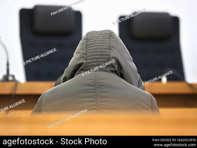 03 March 2020, Bavaria, Kempten: A woman sits in the dock in a courtroom in the district court. She had suffocated her daughter with a pillow in 2016 and was...