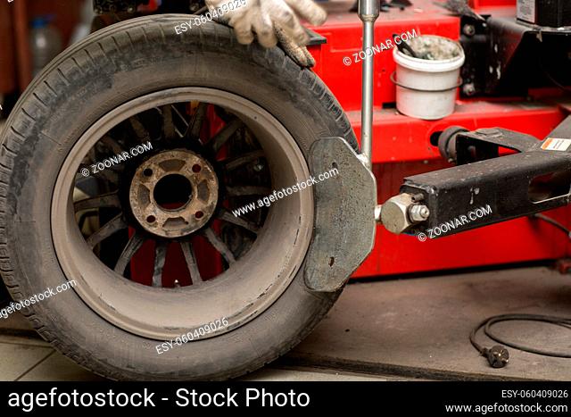 Mechanic changing car tire fitting. Wheel tyre repairing