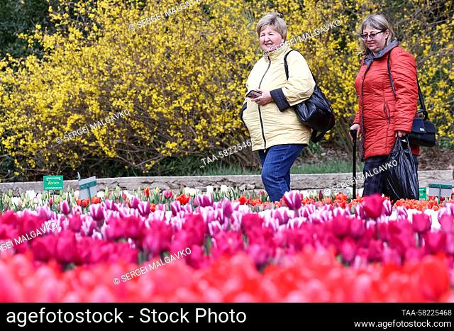 RUSSIA, YALTA - APRIL 4, 2023: Women visit the annual Tulip Parade exhibition at the Nikitsky Botanical Garden. Sergei Malgavko/TASS