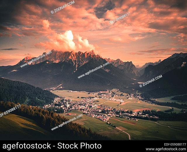 Panoramic view of famous Dolomites mountain peaks glowing in beautiful golden evening light at sunset in summer, South Tyrol, Italy Toblach