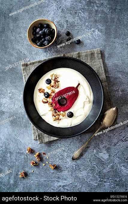 Red wine pear with honey yogurt, granola and blueberries