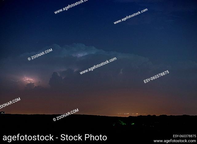 Lightning flashes in a sky during a strong thunderstorm