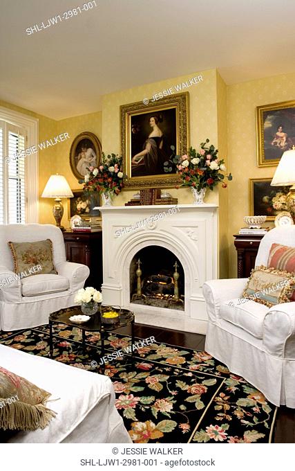 LIVING ROOMS: Romanesque Revival fireplace symmetric vased floral arrangements of roses and tulips, portrait oil painting, slipcovered chairs