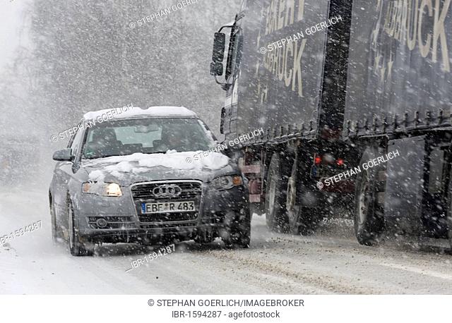 Cars driving on a highway through heavy snowfall in Markt Schwaben, Bavaria, Germany, Europe