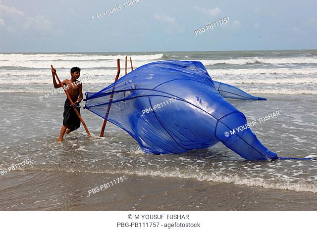 fisherman cacthing Shrimp at The worlds longest stretch of uninterrupted beach has made Coxs Bazar, a popular tourist spot Bangladesh