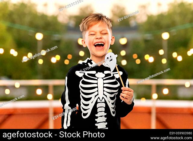 boy in halloween costume with ghost decoration