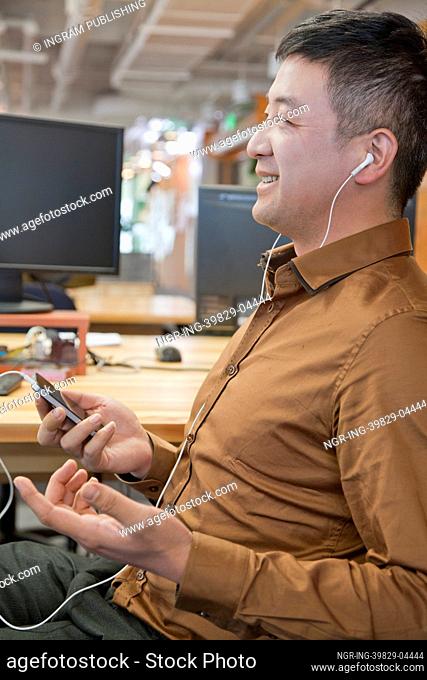 Businessman Listening Music in the Office