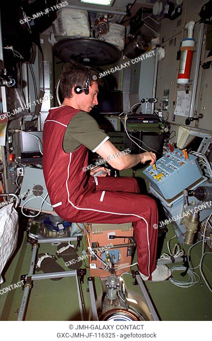 Cosmonaut Sergei K. Krikalev, Expedition 11 commander representing Russia's Federal Space Agency, tests the newly installed Proximity Communications Equipment...