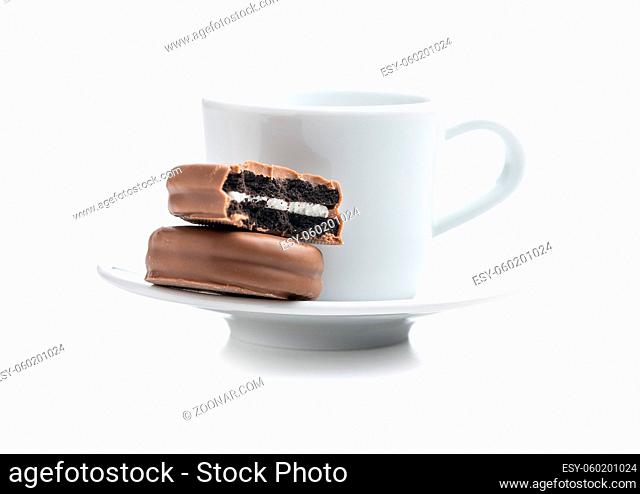 Biscuits with chocolate icing on coffee mug isolated on white background
