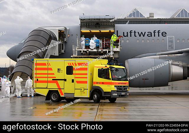 01 December 2021, Saxony, Dresden: Medical personnel from the Bundeswehr prepare to transport Corona patients in front of an A310 MedEvac aircraft from the...