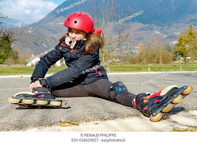 young attractive teenage skater grimacing in pain after taking a fall