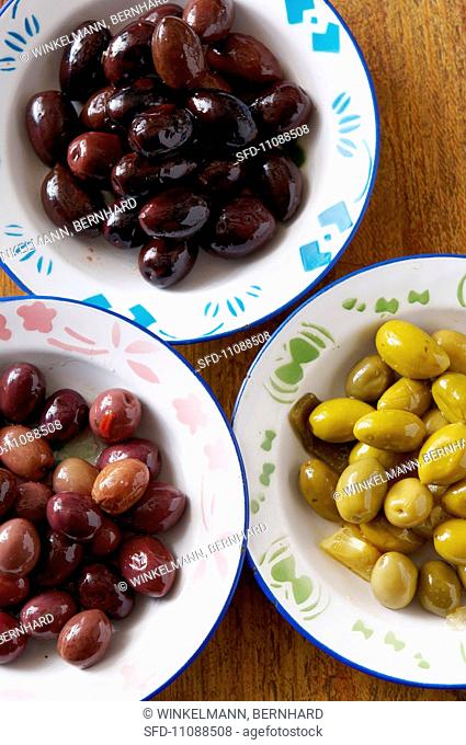 Various types of olives in bowls