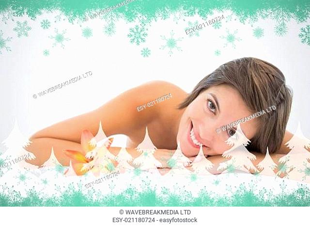 Composite image of close up portrait of a beautiful young woman on massage table