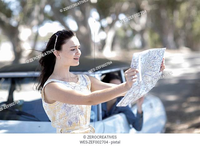 South Africa, Young woman on road trip with friends looking for directions