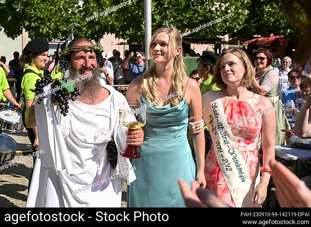 10 September 2023, Saxony-Anhalt, Freyburg: Lea Blumenthal (M), 53rd Saale-Unstrut Regional Wine Queen 2023/24, is escorted to her coronation by Jost Naumann