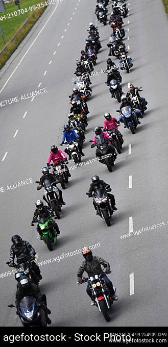 04 July 2021, Bavaria, Munich: Several motorcyclists ride under the motto ""Biker Independence Day Munich 2.0"" in a parade from the Theresienwiese to the...