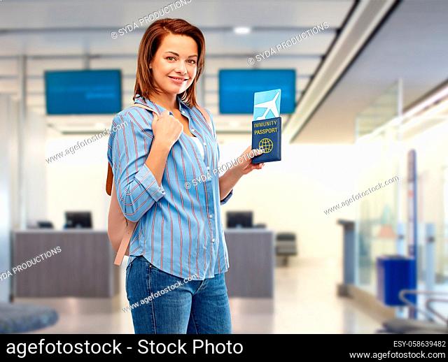 happy woman with air ticket and immunity passport