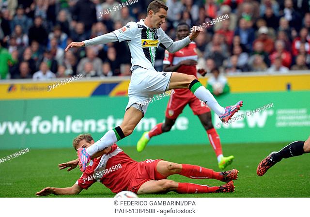 Gladbach's Branimir Hrgota and Stuttgart's Daniel Schwaab vie for the ball during the German Bundesliga soccer match between Borussia Moenchengladbach and VfB...