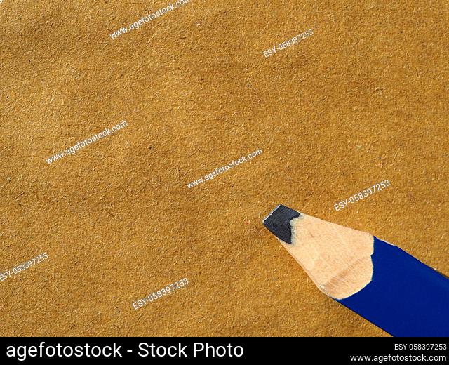 wooden pencil on blank brown paper with copy space