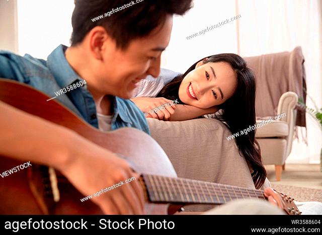 Young man singing to his girlfriend