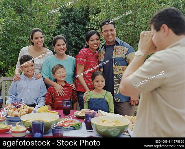 Family smiling for the camera at a barbecue