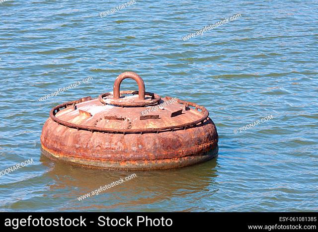Big rusty buoy for the mooring of ships