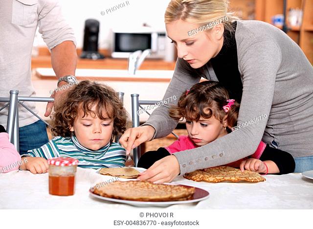 Parents preparing breakfast for children