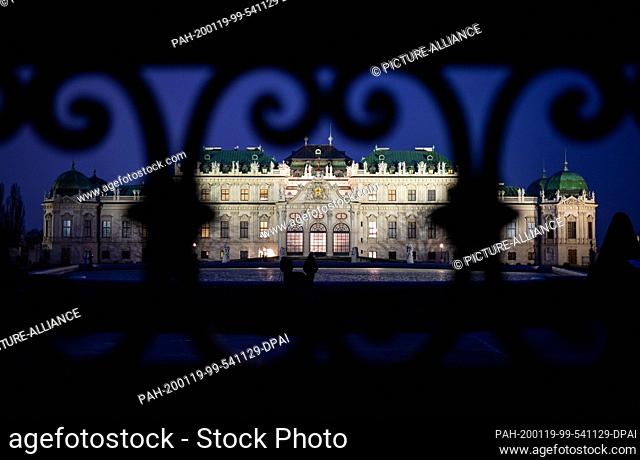 19 January 2020, Austria, Wien: View in the evening in the ""blue hour"" through the entrance gate to the Belvedere Palace in the baroque gardens