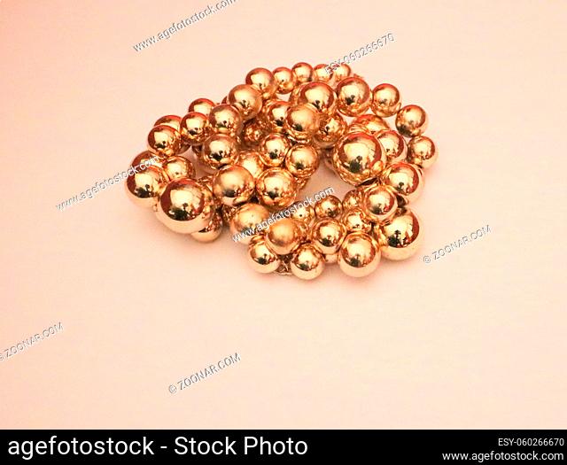 Gold baubles against off white background with space for copy. High quality photo