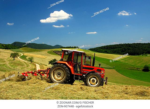 Traktor beim Heumachen auf Wiesen im Schweizer Mittelland, Kanton Aargau, Schweiz / Tractor making hay on meadows in the Swiss Central Plateau, canton of Aargau