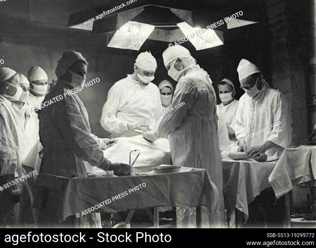 Desert War-And Medicine -- Somewhere in the Western Desert, doctors and nurses of New Zealand unit operate in a tent hospital under lights intensified by the...