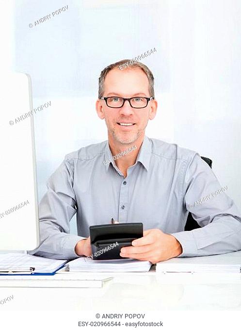 Businessman Using Calculator