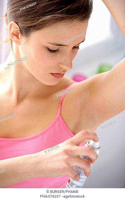 Woman using deodorant