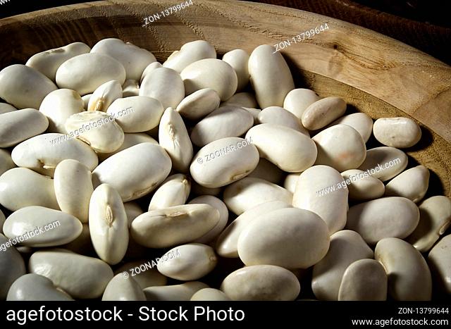 Beans in a wooden plate on the table