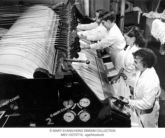 Women factory workers manning a sheet-weaving machine at Patons & Baldwins Factory in Darlington. The company, principally produced knitting wool