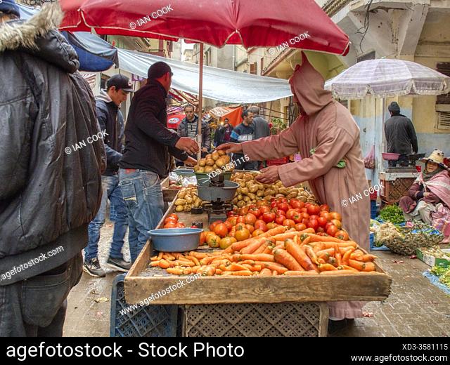 man selling produce in a street market, Tangier, Morocco